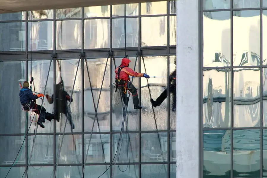 Commercial window cleaners servicing glass building